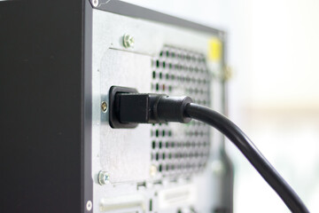 Power cord plugged into Desktop Computer power supply to power it by using AC power from the...