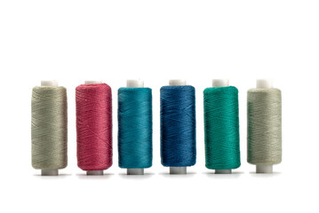 Colorful spools of thread isolated on white background.