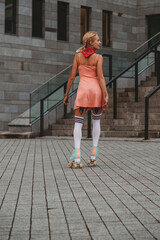 Stylish young woman with vintage roller skates outdoor
