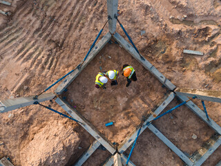 Top view team civil engineer consultant discussion meeting and inspection structure prefabricated concrete in construction site work.