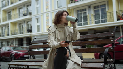 Love couple meeting outdoor. Woman drinking coffee. Man closing girlfriend eyes.