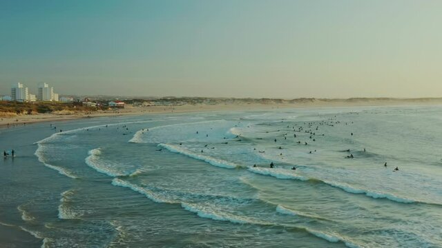 Baleal, Portugal, Europe. Drone footage of people surfing along a shoreline