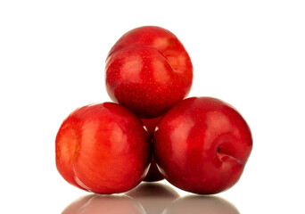 Fototapeta na wymiar Several juicy sweet, red plums, close-up, isolated on white.