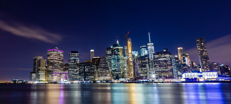 A panorama picture of Manhattan skyline at night with One World Trade Center