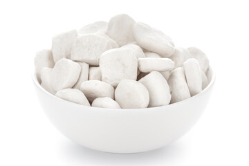 Fototapeta na wymiar Close-Up of organic small white sugar candy (gatta ) in white ceramic bowl over white background