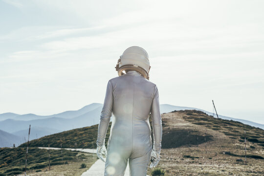 Spaceman standing on path in countryside