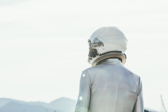 Spaceman standing on path in countryside