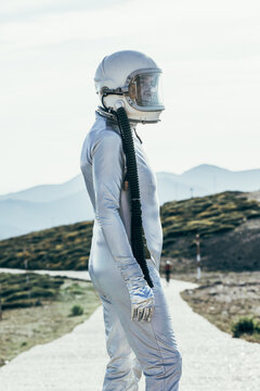 Spaceman standing on path in countryside