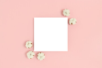 Square paper card mockup with frame made of cotton on a pink pastel background. Eco concept.