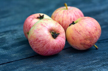 Four fresh apples on the wood