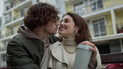 Lovely couple kissing on urban background. Man and woman felling happy outdoor.