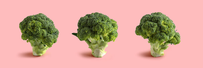 three broccoli on pink background