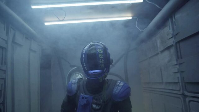 Cyberpunk concept, future world. Police officer halfman bionic cyborg stands with weapon gun in hands in smoky corridor, room area. Science fiction scene, fantasy, sci. Robot. On set