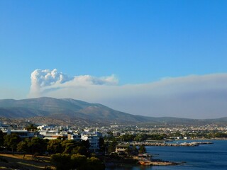 Smoke cloud from a forest wildfire over the town of Varkiza in Attica, Greece