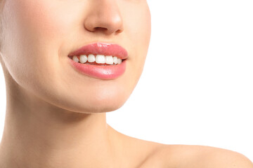 Fototapeta premium Young woman with beautiful lips on white background, closeup