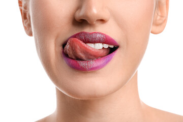 Beautiful young woman with heart on lips against white background, closeup