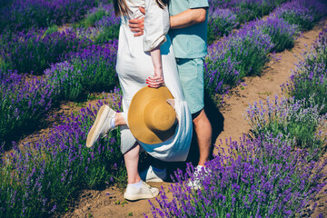 Couple hugging, romantic love story. Beautiful purple lavender flowers on the summer field. Warm...