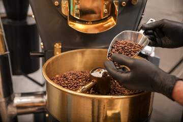 Man using modern coffee roaster, closeup