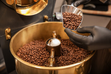 Man using modern coffee roaster, closeup