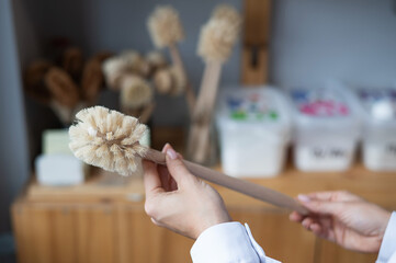 Woman holding eco friendly toilet brush. Natural products with zero waste