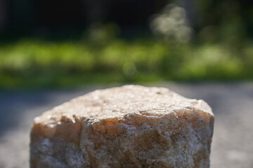 Stone podium display. A natural rock pedestal with a natural green background. High quality photo