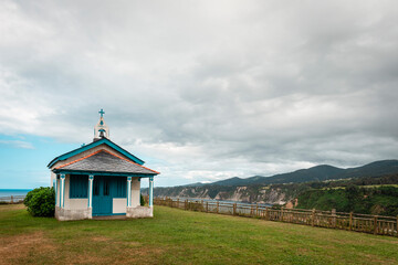 Hermitage in a meadow above a cliff