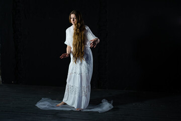 woman in white dress dancing on a black background. blur. object out of focus - obrazy, fototapety, plakaty