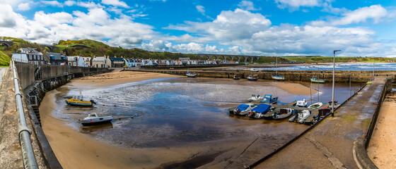 A panorama view across the inner harbour at the town of  Cullen, Scotland on a summers day