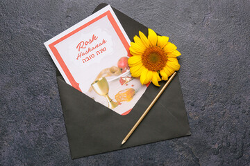 Greeting card for Rosh hashanah (Jewish New Year) with envelope on dark background