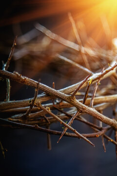 Retro styled image of bloody nails and crown of thorns in the rays of the sun as symbol of passion of Jesus Christ. Christianity and religion concept. Close up.