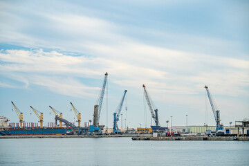 Port of Malaga with cranes and hoists for stevedores and logistics workers