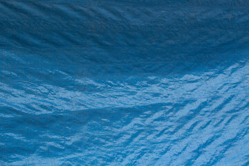 Texture of a blue cloth bag. Blue plastic bag. Fine weave texture.