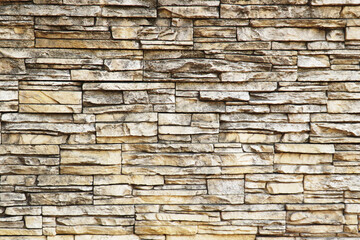   A wall of natural flat stones stacked horizontally. Texture for background.