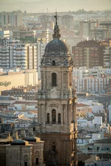 Deurstickers Views of the buildings of the city of Malaga during the sunset, with the Church of the Incarnation © MARIO MONTERO ARROYO