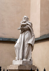Monument statue on the background of the church in Lviv