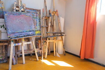 There are many easels for drawing in the art studio. The concept of creativity and art. Items for creativity and ideas.