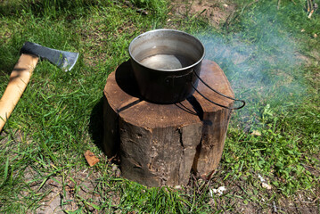 Boiling water on a swedish torch during survival trip