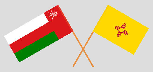 Crossed flags of Oman and the State of New Mexico. Official colors. Correct proportion