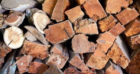 A stack of firewood, folded near the comin.