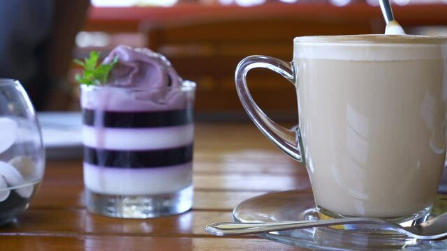 Coffee break at rest tea time after work from home. Making coffee and fresh milk or tea in empty cup on wood table drink with sweet snack dessert cake or cookies and hot drink. Drink cafe.