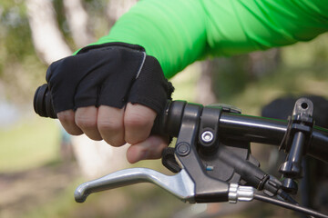 A gloved hand holds the handlebars firmly.