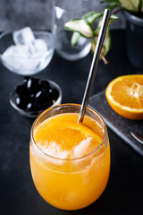 Freshly squeezed orange juice with ice and an orange slice. Refreshing drink with vitamin C