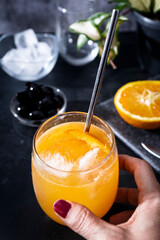 Freshly squeezed orange juice with ice and an orange slice. Refreshing drink with vitamin C
