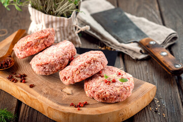 Frozen spicy beef patties with pepper. Butcher minced meat cutlet