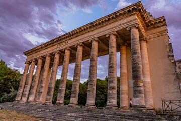 Fototapeta premium Exterior view of ancient roman theater building. Ancient open-air theater near Nimes, France. Rome architecture and landmark. High quality photo