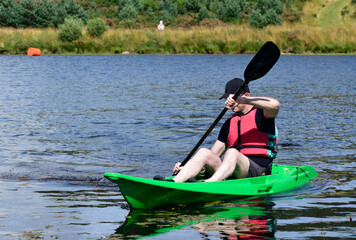 Green kayak in Loch Lomond during summer 