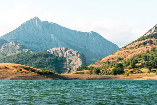 Landscape of the mountains of the Porma reservoir in Castilla y Leon.The photograph is taken from the water's edge, which is reached by a detour along a curvy road that is heavily visited by motorists