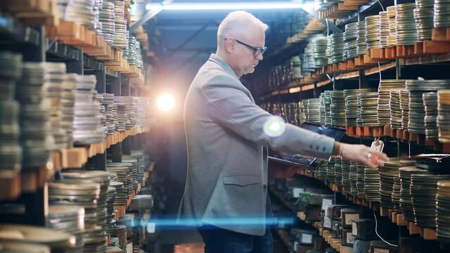 Film expert is registering old movie cases into laptop