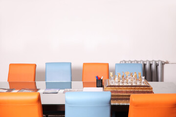 Meeting table in the office with bright blue and orange chairs