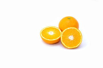 Isolated on a white background are two oranges: one whole, the other cut in half.
